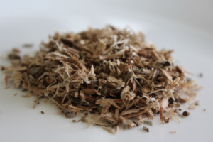 A close-up of a pile of natural, coarse, shredded wood chips on a white background.